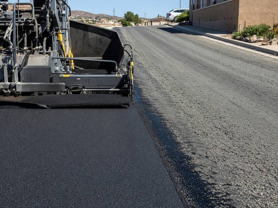 Tack coat going down before a new wearing course — asphalt driveway resurfacing in Riverside, CA